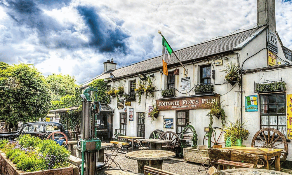 Johnnie Fox's pub exterior on a sunny day with chairs 